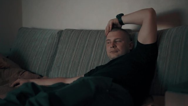man watching tv on the couch