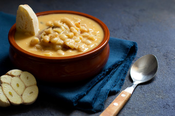 White bean stew, pasulj, bread, traditional balkan cuisine, dark background