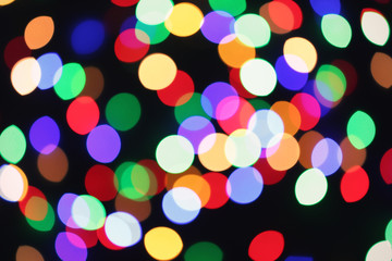 Beautiful colorful lights on dark background. Bokeh effect