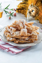 Traditional Italian carnival fritters dusted with icing sugar - frappe or chiacchiere