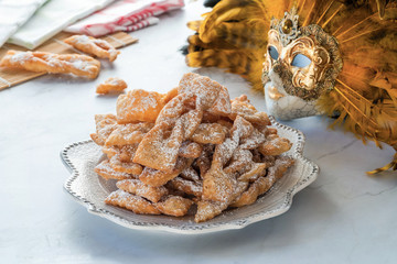 Traditional Italian carnival fritters dusted with icing sugar - frappe or chiacchiere