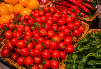 Background, texture from bright tomatoes from kitchen garden and green pepper in baskets. Healthy lifestyle, food.