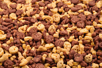  Chocolate flakes in the form of skulls and bones background. Top view.