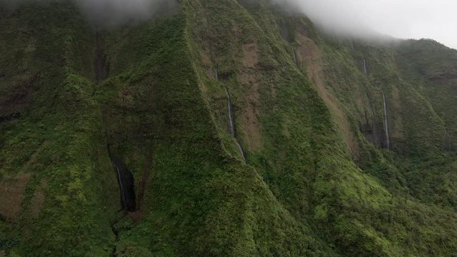 Helicopter tour of the volcanic crater on Na Pali coast in Hawaiian island of Kauai