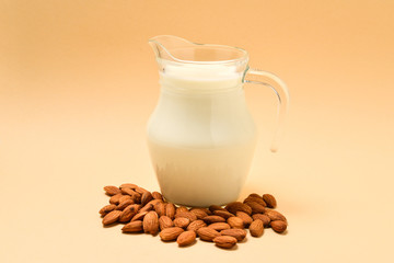 A jar with almond milk, nuts. Space for text or design.