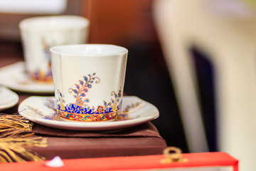 Vintage Thai's style porcelain coffee cup handmade. Beautiful traditional Thai five-colored porcelain ceramic coffee cup. Benjarong Porcelain coffee cup for sale in the flea market, Thailand.