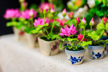 Cute Artificial pink lotus flowers or Water Lily. Artificial lotus flower, handmade clay lotus flower with green leaf and pink petal, DIY art product for home or temple decoration.