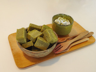 Green tea brownie and cream desert set on wood tray plate.