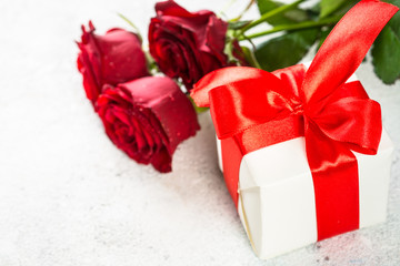 Red roses flower and present box on white. 