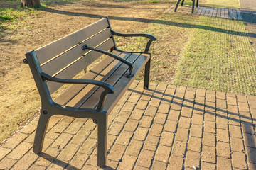 An waiting wood bench in the outdoor garden park.