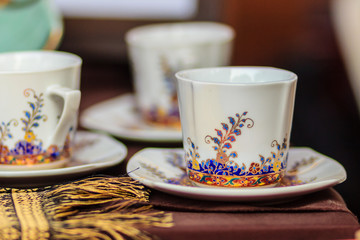 Vintage Thai's style porcelain coffee cup handmade. Beautiful traditional Thai five-colored porcelain ceramic coffee cup. Benjarong Porcelain coffee cup for sale in the flea market, Thailand.