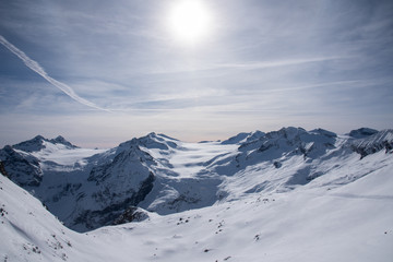 View of the Presena glacier at 3100 meters of altitude and the mountains around the Tonale Pass, during a winter sunny day. Tonale is a mountain pass between Lombardy and Trentino