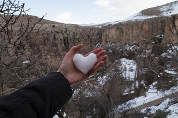 valentines hold heart which is made by snow in Nevsehir. Cappadocia and Ihlara valley concept