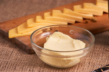 Butter and chees and milk for breakfast, over rustic wooden background with copy space. Morning breakfast
