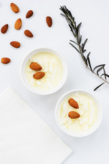 Panna cotta with almonds on a white table