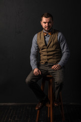 Fototapeta na wymiar Stylish young man in wooden bowtie. Business style. Fashionable image. Office worker. Sexy man standing and looking at the camera