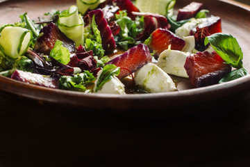 Salad with tuna, cheese and greens. Backlight.