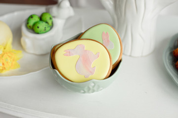 Easter spring decorative composition with homemade easter cookies in the shape of a funny rabbit, quail eggs