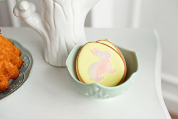 Easter spring decorative composition with homemade easter cookies in the shape of a funny rabbit, quail eggs