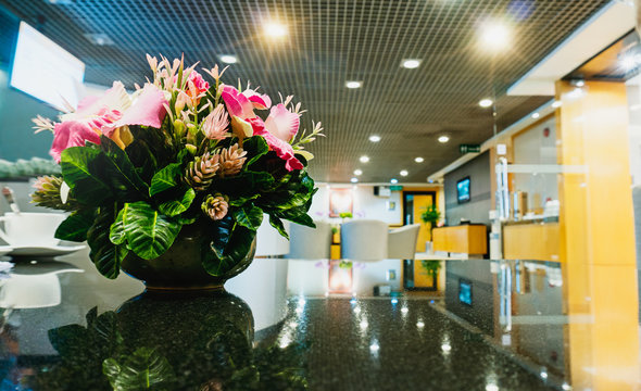 Flowers vase on table in lobby area with copy space