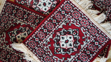 Bright colorful weaved floor mat. Turkish ornamental carpet background. Woven texture. Ethnic pattern rug. Traditional Asian ornaments. Turkish bazaar backdrop.