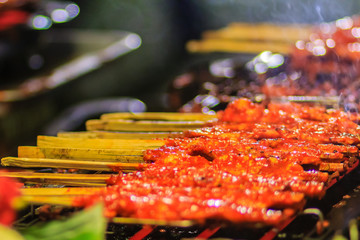 Close up vendor during grilling Southern spicy chicken. 