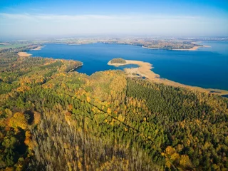Fotobehang Aerial view of beautiful landscape of Mazury region during autumn season, Mamry Lake in the background, Poland © Mariusz Świtulski