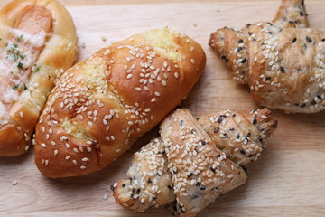 Bread and croissant on wooden table