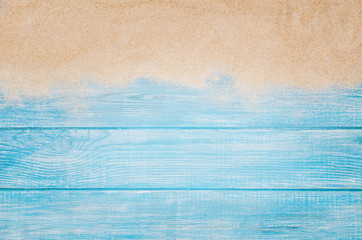 Top view of sandy beach and marine blue planks pier. Background with copy space and visible sand...