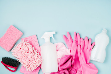 Detergents and cleaning accessories  in pink color.  Cleaning service concept. Flat lay, Top view.