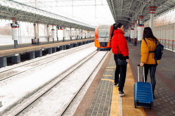 Fototapeta premium Young females walking railway platform