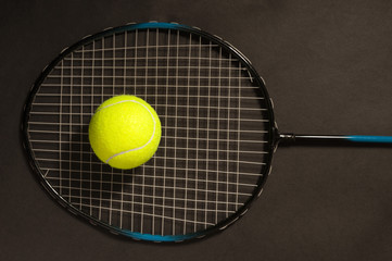 Green tennis ball and racket