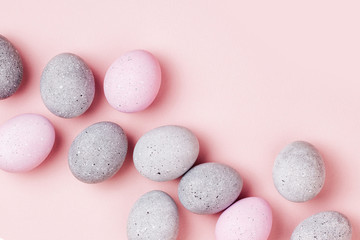 Obraz na płótnie Canvas Stylish background of pale pink and gray Easter eggs. Dyed Easter eggs. Flat lay