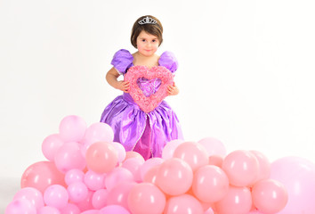 Fototapeta na wymiar Love. Kid fashion. Little miss in dress. Little girl princess. Childhood happiness. Party balloons. Happy birthday. Childrens day. Small pretty child with decorative heart. I will be your Valentine