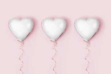 Single Balloon of heart shaped foil on pastel pink background. Love concept. Holiday celebration. Valentine's Day or wedding/bachelorette party decoration. Metallic balloon