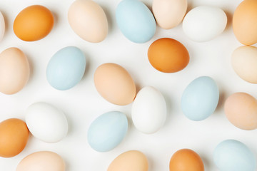 Natural Colored brown and white Eggs on light background. Compositions in pastel colors. Easter consept.  Flat lay, top view