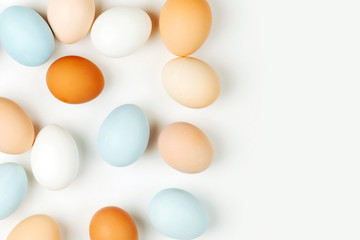 Natural Colored brown and white Eggs on light background. Compositions in pastel colors. Easter consept.  Flat lay, top view