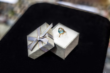Elegant ring with topaz on black background