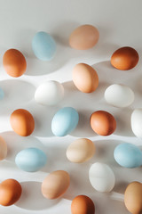 Natural Colored Eggs with sunlights. Compositions in pastel colors. Easter consept.  Flat lay, top view