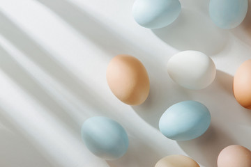 Natural Colored Eggs with sunlights. Compositions in pastel colors. Easter consept.  Flat lay, top view