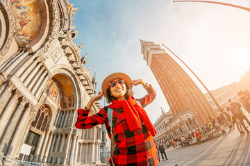 Fototapeta premium Young happy asian girl traveler on San Marco square in Venice. Vacation and holidays in Italy and Europe concept