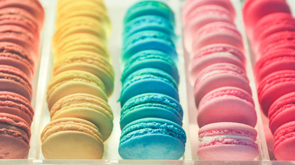 Colorful macaroon sweets on shelves