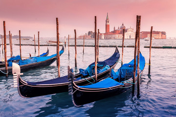 Majestic Gondolas in Venice at the sunset. Panoramic view of the San Giorgio Maggiore church from...