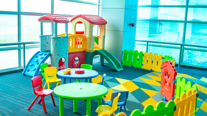 colorful playground facility near the windows. 