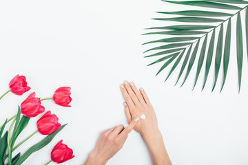 Female's hands put cosmetic cream