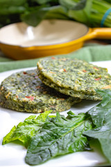 Healthy vegetarian or vegan food, uncooked green spinach burgers, ingredient for hamburgers