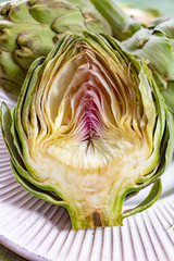 Obraz premium Heads of fresh uncooked artichoke flowers close up