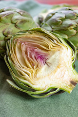 Heads of fresh uncooked artichoke flowers close up