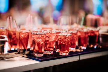 Beautiful red, alcoholic summer cocktails ready to be served