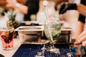 Professional cocktails details - mojito and summer drinks at bar counter